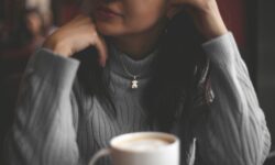 cup of coffee in front of woman
