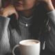 cup of coffee in front of woman