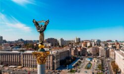 a view of a city with a statue in the middle