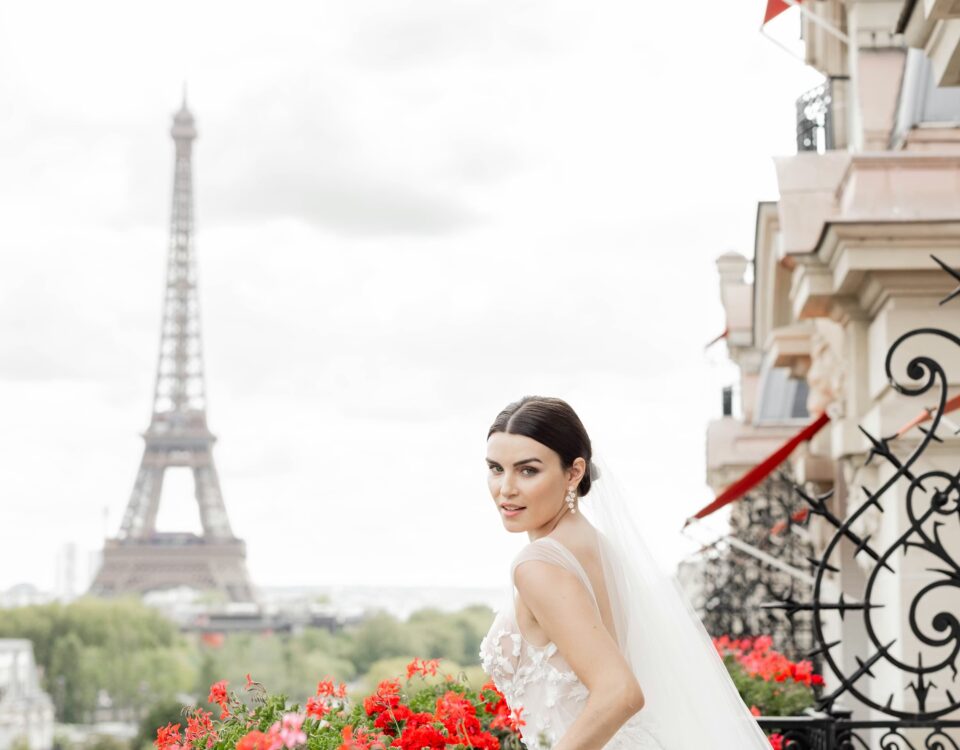 A bride standing in front of the eiffel tower